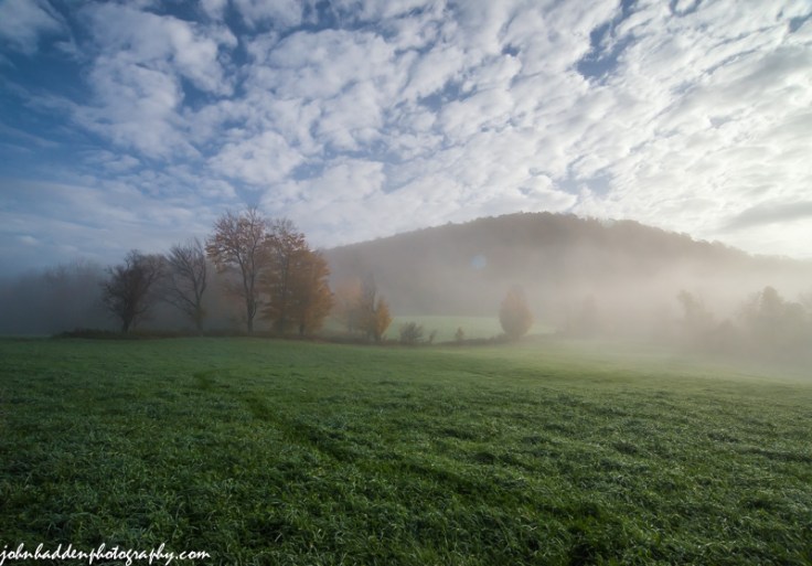 Morning fog burns off under a mackerel sky