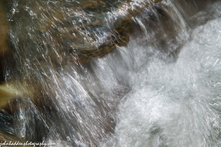 Water over rocks like cellophane